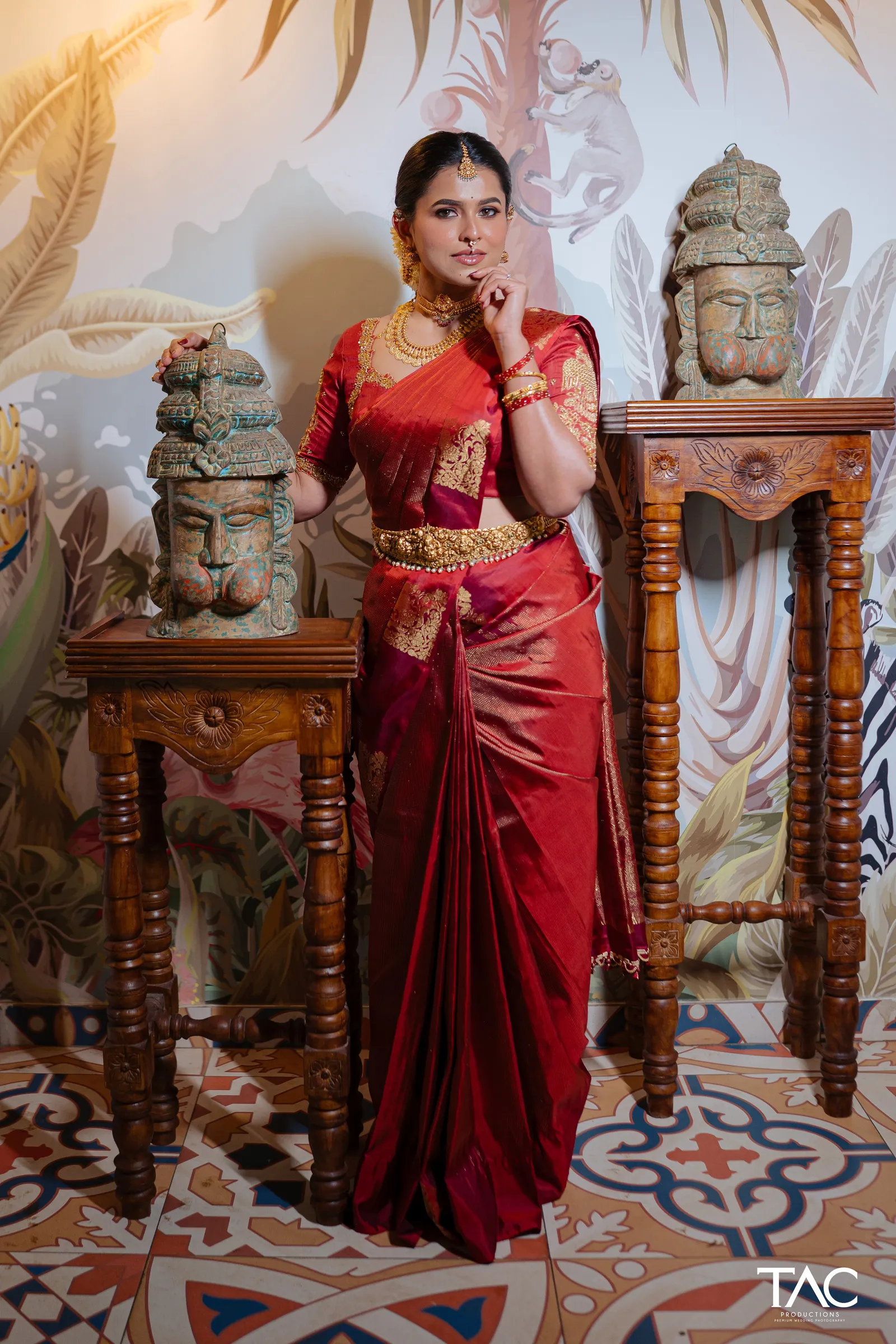 Bride in red Kanjeevaram amid carved wooden decor, Manthan Beach Resort, Udupi